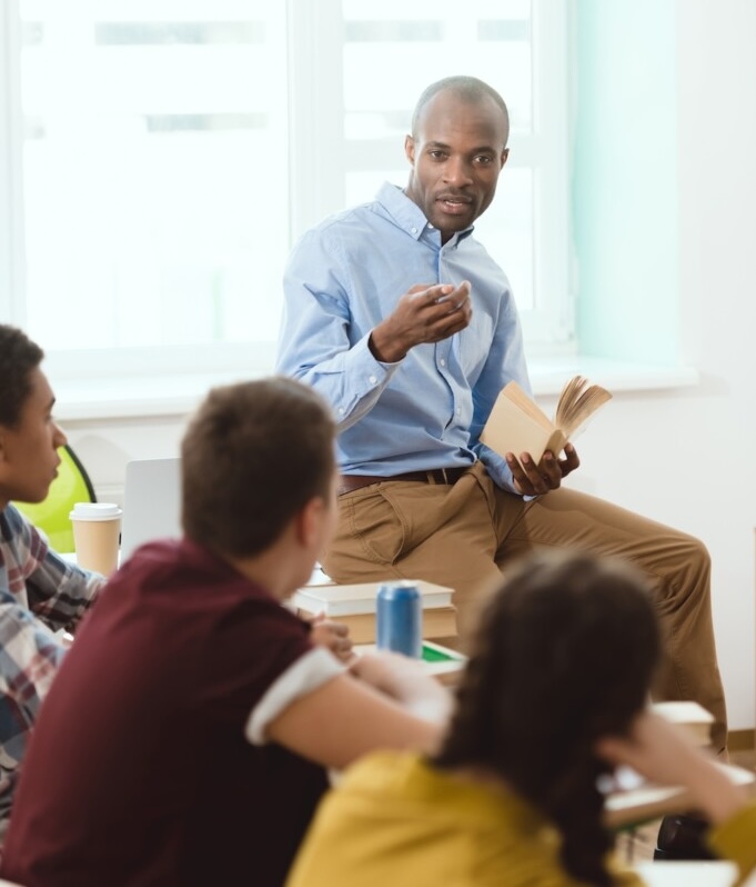 teacher performing lecture for high school students